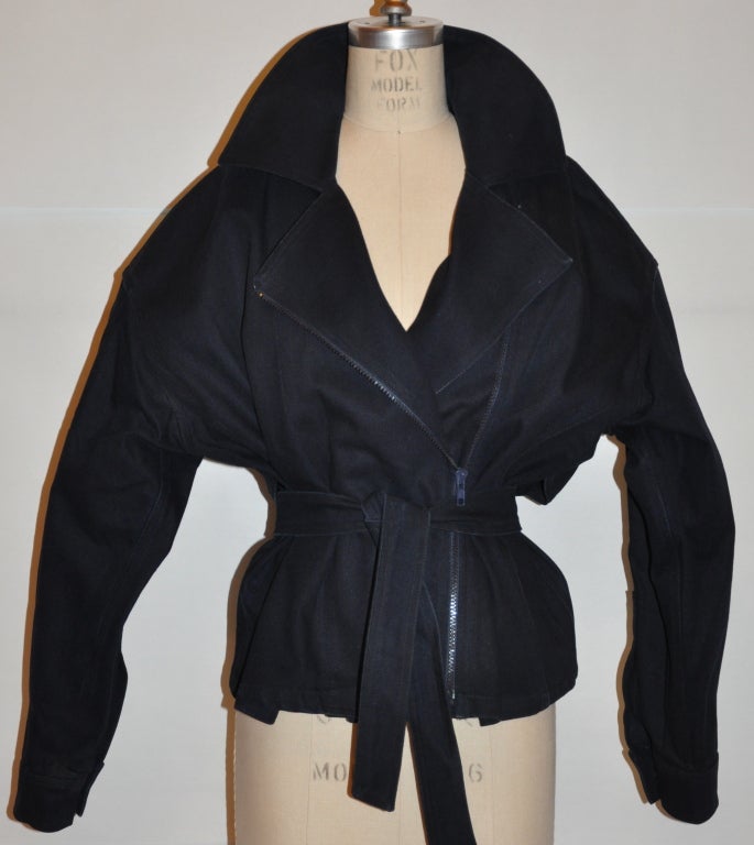 This Carolyn Roehm cotton navy zipper jacket is fully lined, and also has attached wrap belts of the same material. The zipper is styled off toward the side and the high collar makes for a more extreme look. The zipper measures 19 1/2