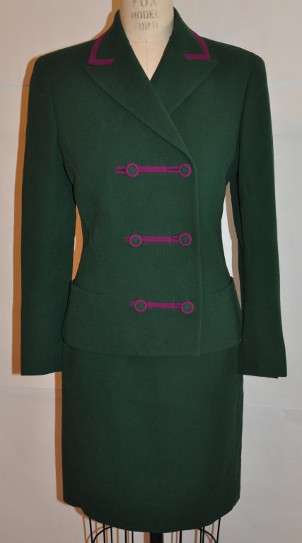 Gianni Versace Couture two-piece ensemble is Green with detailing of deep Fuchsia hue. The suit is double breasted and fully lined. The sleeves cuff have two buttons detailing. The skirt has a center back invisible zipper which measures 8