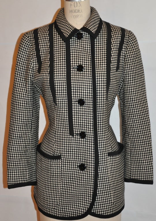 Valentino black & white wool jacket if fully lined. There are wonderful detailed silk ribbon embellishment throughout the jacket along with the covered buttons, and all silk ribbons have fine top stitching. There are two patch pockets in front.