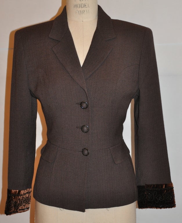 Baumarine brown wool herringbone jacket has coco-brown velvet cuffs with glass micro-seed bead embellishment. The jacket is fully lined with three front buttons. there are two front waist 