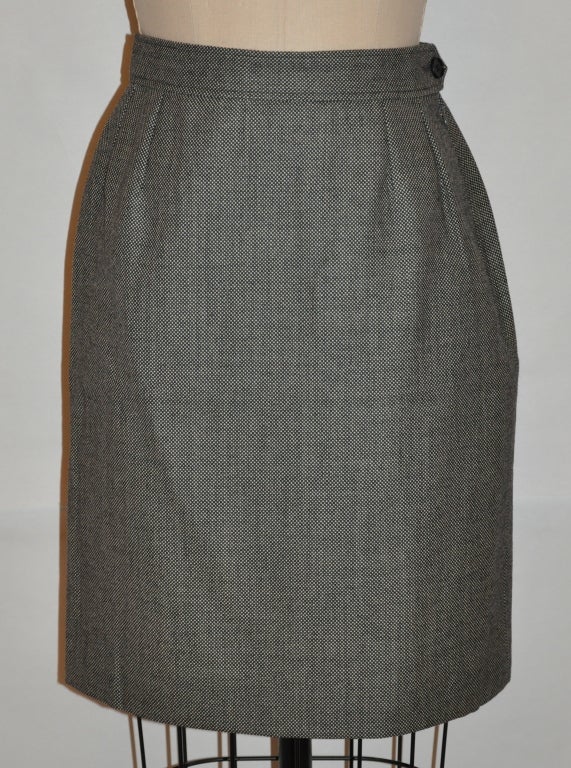 Yves Saint Laurent skirt is fully lined in black silk. The side invisible zipper measures 7 1/8