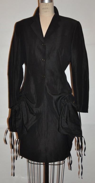 This black Jean Paul Gaultier silk-linen blend ensemble has nine (9) 'drawstrings' stationed on all sides of the jacket, two in front, two in back, and one on either sides of the jacket. You can draw one or all of the strings to make the jacket up