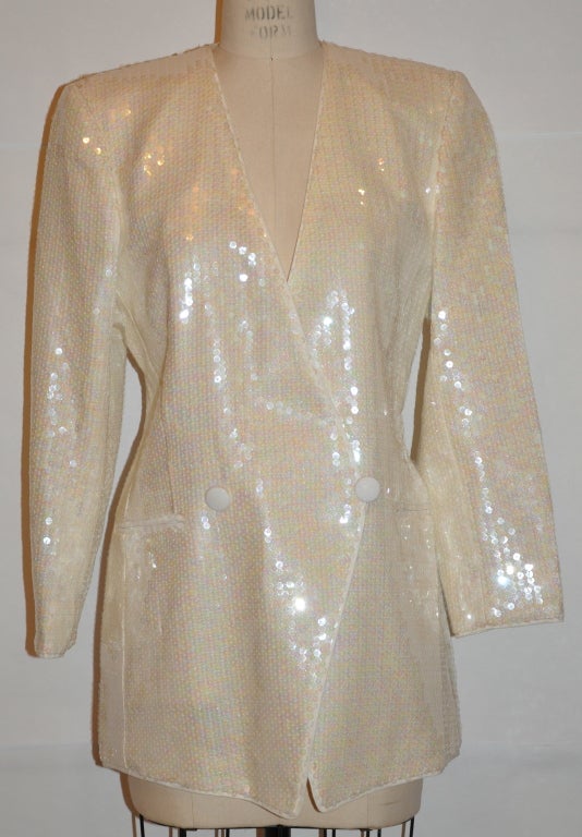 Escada jacket by Margaretha Ley is in white linen and the lining is also partically lined in linen also. The jacket is covered with irredescent sequins. The buttons are linen covered. The front hem is slightly pointly.
  The front measures 20