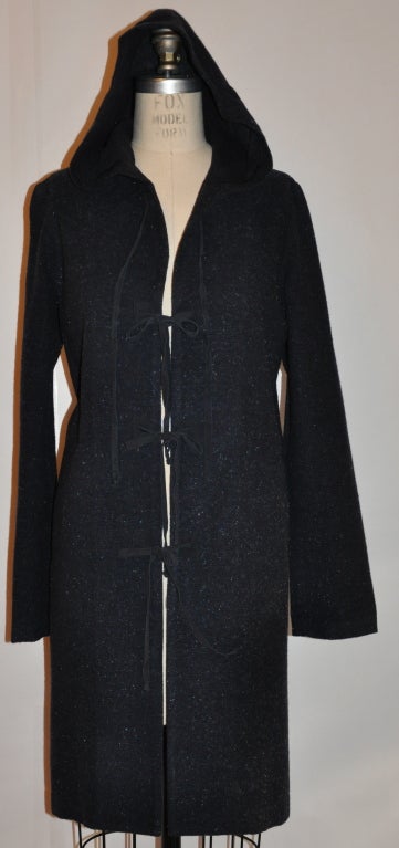 This wonderful Midnight blue jacket has iridescent  threads throughout the wool blend hooded jacket. The interior seams are all covered with silk ribbon.The suede ties on front measures 15 1/4