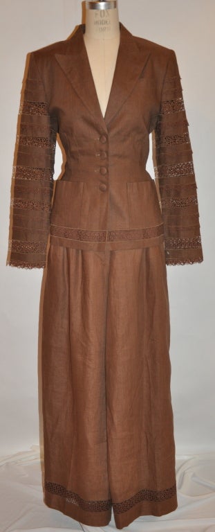 Lolita Lempicka fully lined brown linen and flax blend pant ensemble is wonderfully detailed with handmade Swiss lace throughout. The ensemble is fully lined with silk of the same brown hue. There are two patch pocket in front and one breast