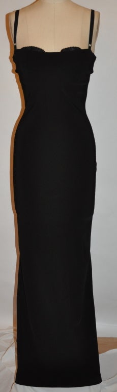 This wonderful Dolce & Gabbana black spandex-blend is not for the faint of hearts! Elgant yet sexy all-in-one black dress. The cocktail gown has a built-in under-wire bra that purposely shows a little over the dress. The center-back has a eighteen