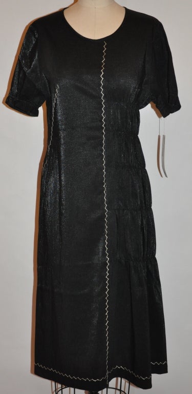 Nobu Nakano Black linen-blend dress has cream hand-embroidery accents also with hand-stitched gathering on one side of the dress and also on the sleeves. The embroidery is done with a silk & cotton blend. The center back zipper measures 20