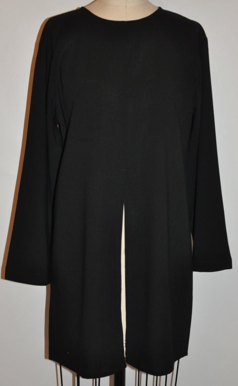 Rene Lezard for Bergdorf Goodman Black lightweight wool tunic has a center high-slit on both the front and back. There are two patch pockets measuring 4 3/4