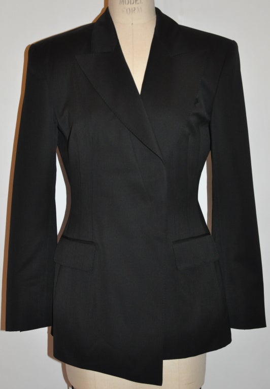 Rare Yves Saint Laurent Rive Gauche black asymmetric style blazer is fully lined with detailed hand-sewn top stitching along the lapels and collar. The front has a single button that is hidden and not shown when buttoned. The cuffs has detailed