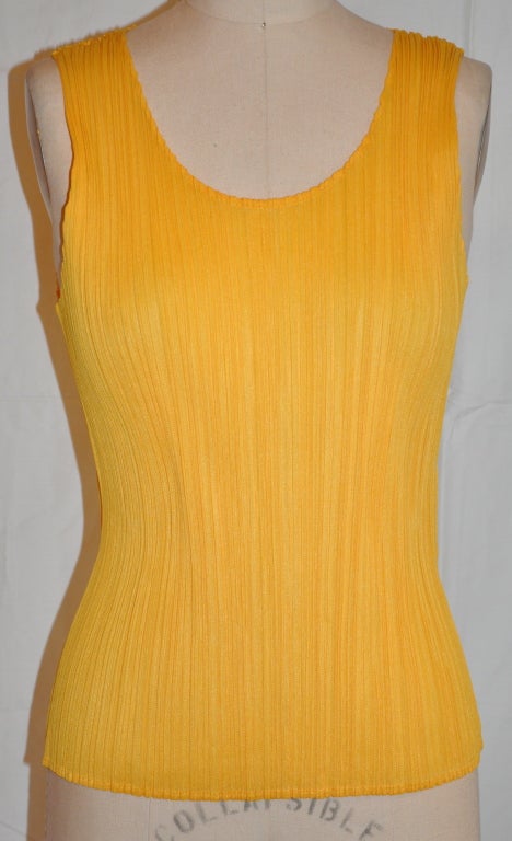 Issey Miyake signature pleated material in taxi-yellow styled into a tank top.
   The front length measures 16