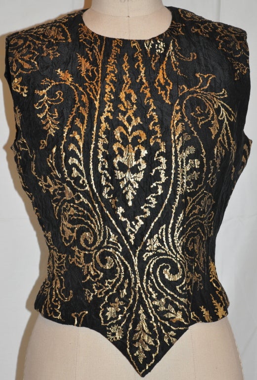 This wonderfully elegant evening top has hidden silk covered snaps (five in all). The black silk evening top with metallic gold accents in a leaf motif can be worn as shown, or with the front half-way open. 
   The top is fully lined. The front