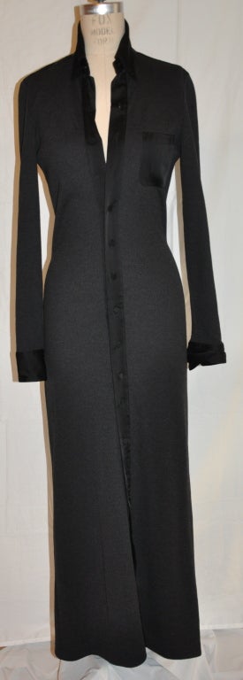 Jean Paul Gaultier black maxi-length cardigan is accented with black satin borders on front and also on the sleeves cuffs.
   The front is detailed with sixteen(16) buttons, as well as on the cuffs.
   The waist measures 27 inches, back