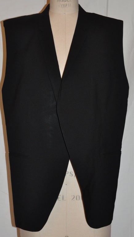 Comme des Garcons black deconstructed tuxedo jacket is sleeveless and measures 27 1/4