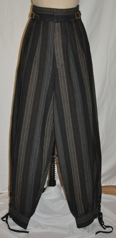 Jean Paul Gaultier men's multi-colored stripe trousers has lace-up accents along the leg's cuff measuring 5