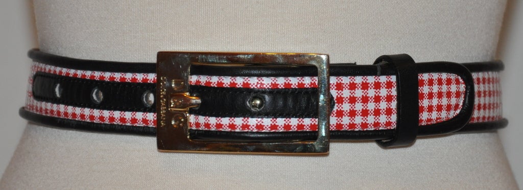 This Dolce & Gabbana leather belt has red & white checkered print with navy piping trim.
   The width measures 1 1/8