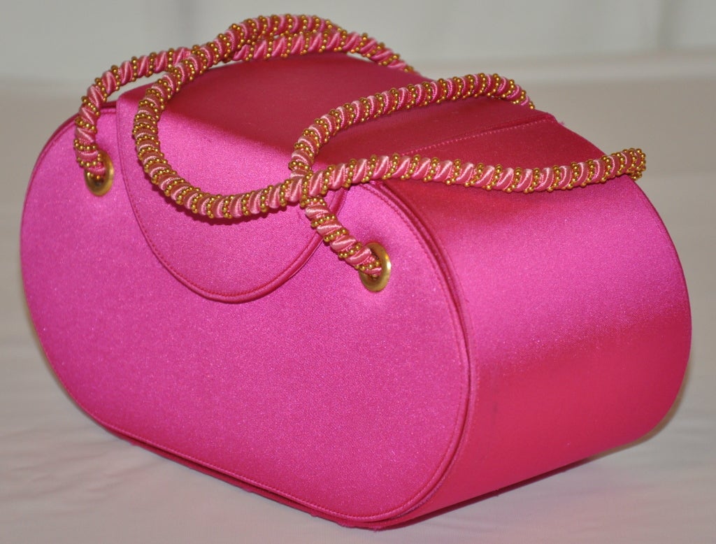 Renaud Pellegrino neon fuchsia silk evening bag has double handles of fuchsia silk and gold hardware chain.
  There are four (4) gold hardware footing on the bottom for better wear.
  The double handles measures 6