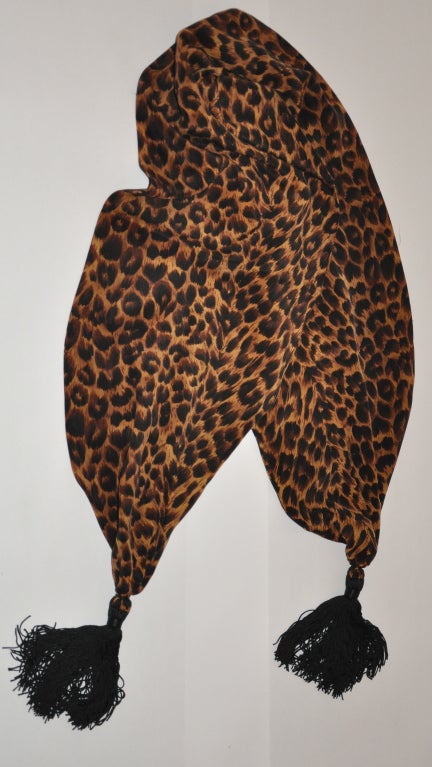 Dana Buchman's double-layered silk scarf in printed leopard is highlighted with tassels on both ends. Scarf measures 12