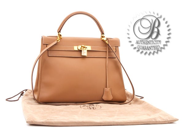 This is an authentic HERMES Natural Barenia Kelly 32 cm GHW Bag. It is done in gorgeous Natural leather with gold hardware. It features a single rolled leather handle and the signature Hermes flap top closure with leather strap over round clasp