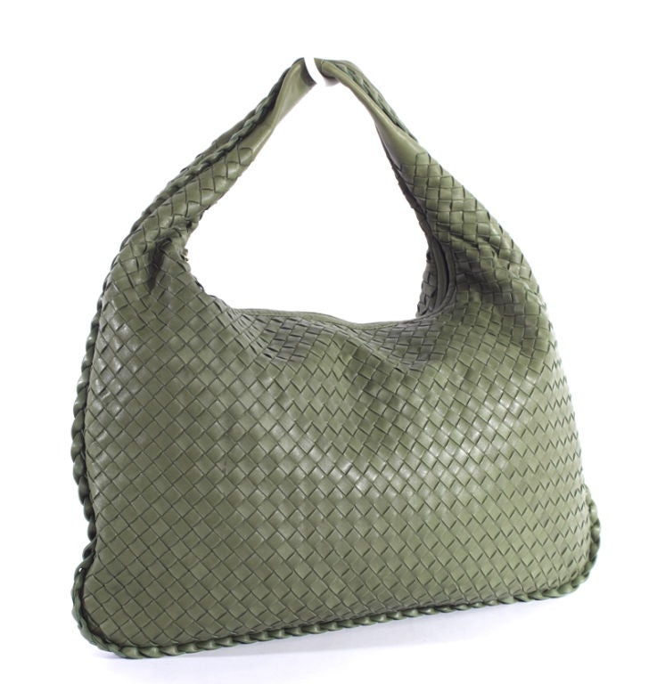 This is an authentic BOTTEGA VENETA Regent Green Woven Large Woven Hobo Bag. It is done in soft and supple green leather with signature Bottega Veneta woven leather pattern on the body of the bag. The bag features a single woven leather handle and a