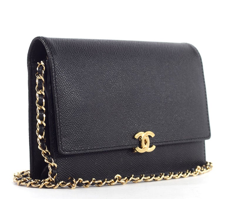 This is an authentic Chanel Black Wallet on a Chain bag. Done in lovely black Caviar Leather, this bag closes with a tuck flap and has the signature Chanel interlocking CC logo closure on the front. The leather strap chain is very versatile and can