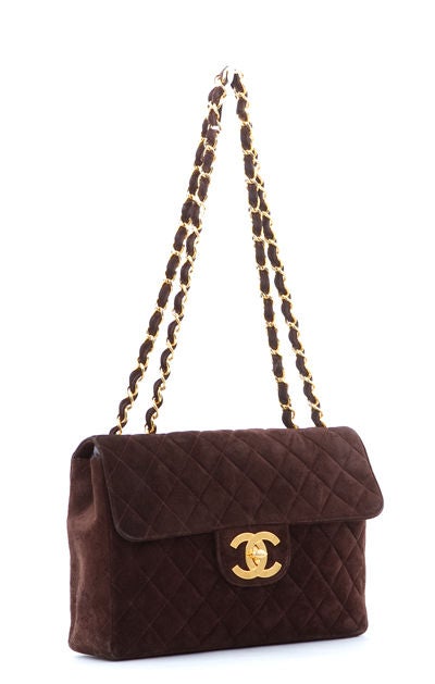 This is an authentic Chanel Jumbo Flap Chocolate Purse Bag. It is done in gorgeous chocolate suede with bright gold hardware. The bag features a signature Chanel kiss lock and flap and a classic quilted exterior. The interior is spacious for all of