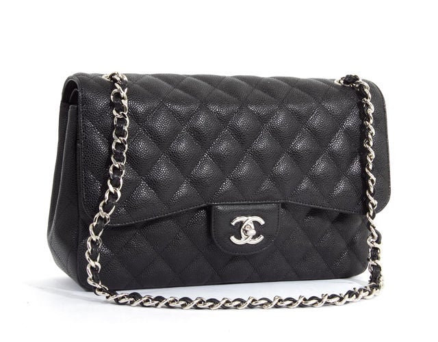 This is an authentic CHANEL Black Quilted Caviar Leather Maxi Jumbo Double Flap Bag. It is done in classic Chanel quilted black caviar leather. This bag features a double flap, shiny silver hardware, and a long chain and leather strap that can be