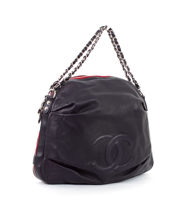 This is an authentic CHANEL Perforated LTD ED Baseball Spirit Large Hobo Bag Rare. This lovely rare bag is done in navy blue perforated calfskin leather with silver tone hardware. The interlocked C Chanel logo sits on the front exterior of the bag.