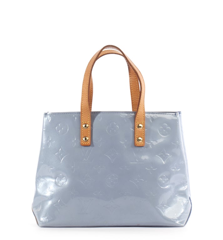 This is a guaranteed authentic Louis Vuitton Baby Blue Vernis Reade PM Bag. It is done in glossy embossed monogram vernis leather with vachetta leather trim, and golden tone hardware. It features two flat carrying handles and an open top.The