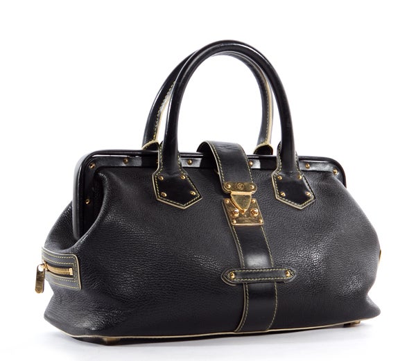 This is an authentic Louis Vuitton Black Suhali Leather L'Ingenieux PM bag. It is done in special addition Suhali goat leather with gold toned hardware and white contrasting stitching. The bag features a framed top, two rolled leather handles, two