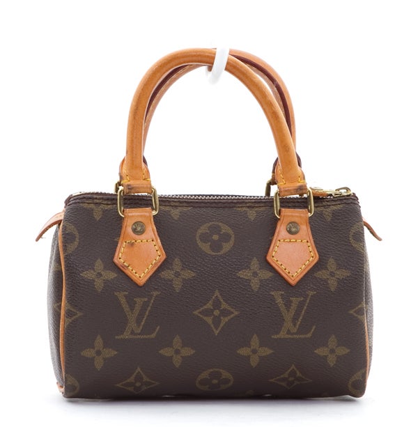This is an authentic Louis Vuitton Monogram Canvas Mini HL Speedy Bag. If you are looking for the perfect bag to hold just the bare essentials, or perhaps a little girls fav, your search stops here! This bag is fashioned out of the traditional Louis