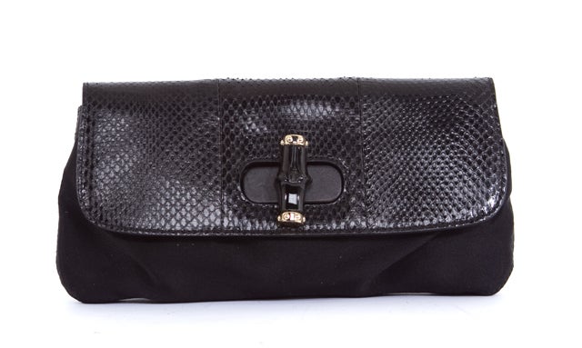 This is an authentic GUCCI Black Snakeskin Bamboo Turnlock Satin Clutch Bag. It is done in a black satin material with a snake skin flap and bamboo hardware turn lock closure. The interior is done in coordinating black satin and features a flat side