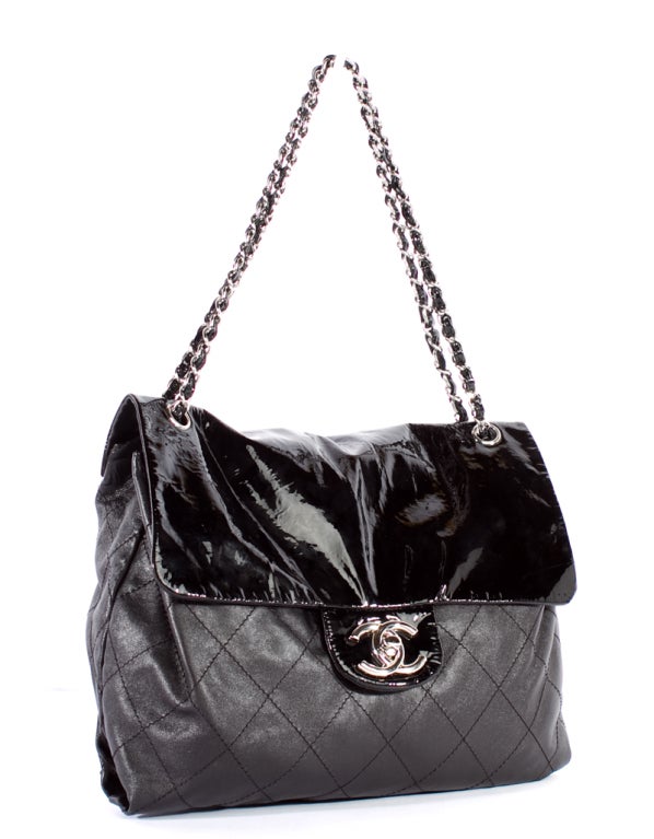 This is an authentic CHANEL Black Lamb & Patent Quilted Jumbo Maxi SOFT Flap Bag. It is done lovely black smooth lambskin leather with elegant silver hardware, and the flap top closure is done in glossy black patent leather. It features signature