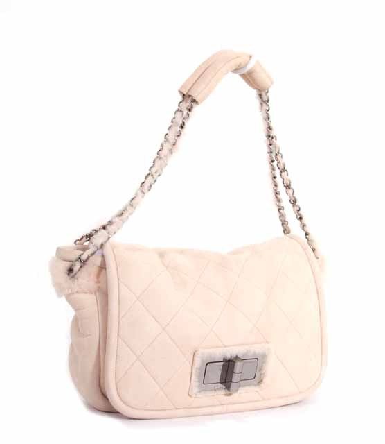 This is an authentic CHANEL Suede & Shearling Mademoiselle Flap Shoulder Bag. It is done in luscious suede and shearling. This bag features a double chain and suede shearling shoulder strap, a large turn lock closure with Chanel logo, and shiny