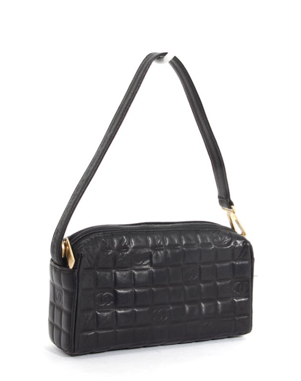 This is an authentic CHANEL Black Lambskin Cube Chocolate Bar Pochette Bag. It is done in soft Chanel lambskin with cube detail. This bag is perfect to carry during the evening! This bag features signature Chanel 