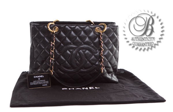 This is an authentic Chanel Grand Shopping tote. Done in beautiful caviar leather, this bag is wonderful It is classic quilted leather, chain straps with padding on the shoulders, and an interior lined in soft fabric. This bag has all of the tenants