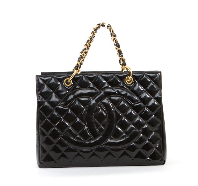 This is an authentic CHANEL Black Patent Leather Quilted Petite GST Bag. Done in lovely black patent leather with gold hardware, this bag features a quilted stictch pattern with the interlocking CC Chanel logo stitched on the front of the bag. The
