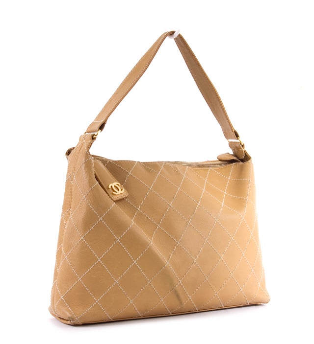 This is a fabulous and absolutely guaranteed authentic CHANEL Beige Camel SURPIQUE Contrast Stitch Tote Bag. Done in signature Chanel quilted lambskin leather with CC logo and contrast Surpique Stitch detailing, this elegant classic is sure to add a