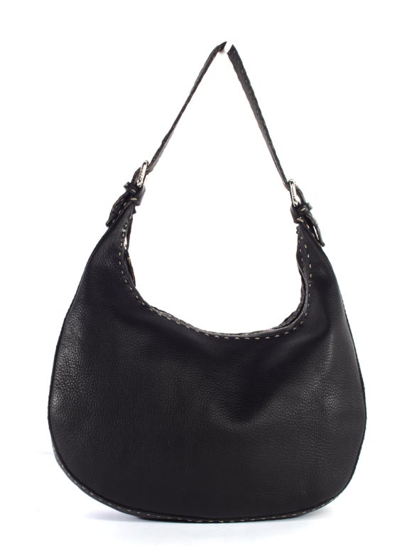 This is an authentic FENDI Black Selleria Hobo Bag. It is done in luxurious black cowhide leather, with silver toned hardware and gray topstitching details. The bag features a zipper top closure, as well as a single flat adjustable leather shoulder
