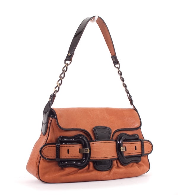 This is a guaranteed authentic FENDI Tan Nappa Baby B Bis Bag Black. It is done in amazing tan nappa leather with black patent leather trim and a pebbled base. It features large buckle exterior accents and a flap closure. There is a brushed bronze