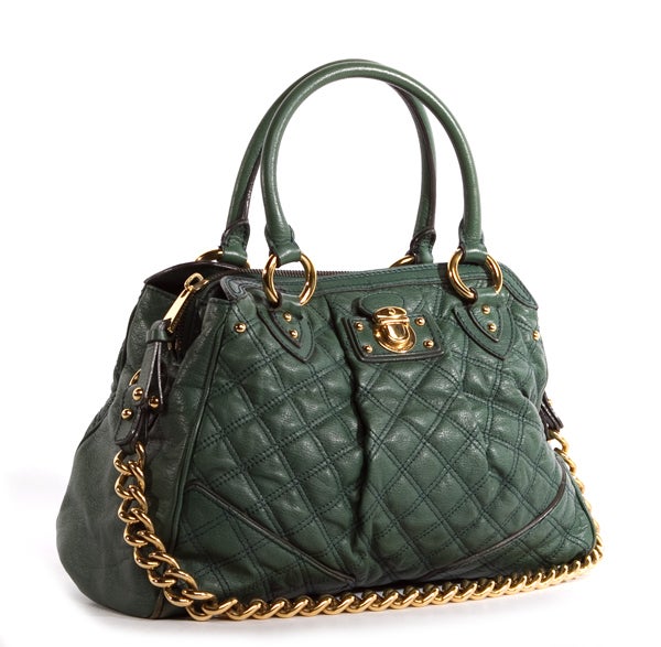This is an authentic Marc Jacobs Green Quilted Alyona Tote bag. It is done in gorgeous emerald green quilted leather with elegant gold hardware. The bag features two comfortable rolled leather handles, and a long chain shoulder strap. It has an open