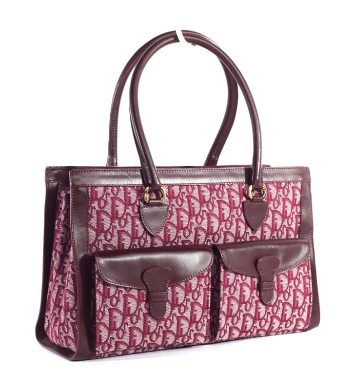 This is an authentic, vintage Christian Dior Red Monogram Satchel handbag. Done in classic, signature Christian Dior red monogram canvas with coordinating cranberry red leather trim, and elegant golden brass hardware, this bag is a great addition to