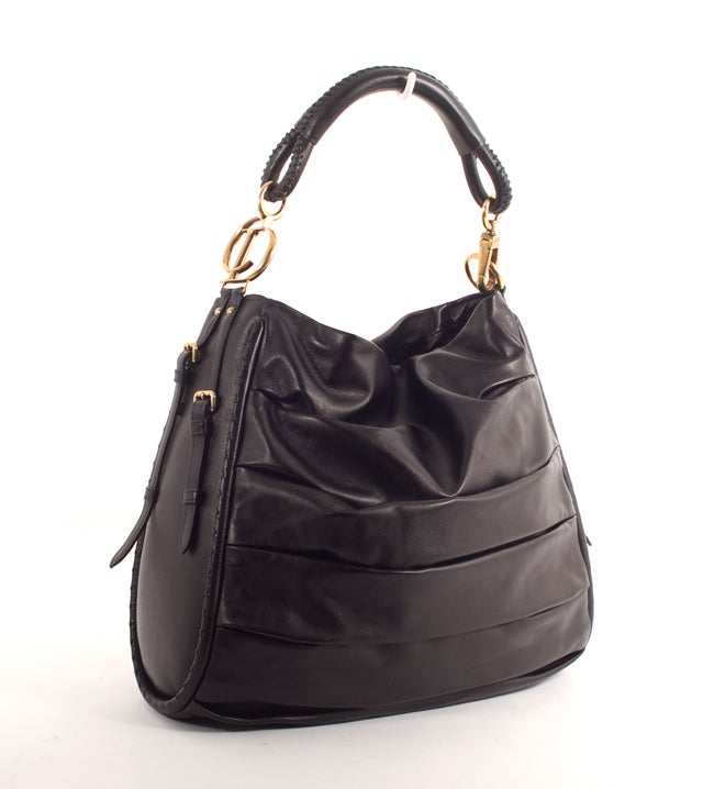 This is an authentic, rare CHRISTIAN DIOR Black Pleated Lamb LIBERTINE XL Bag. Done in lovely black lambskin, it features an exterior pleated design with rolled leather trim, handles and gold hardware. The  bag also has two buckles on both side for