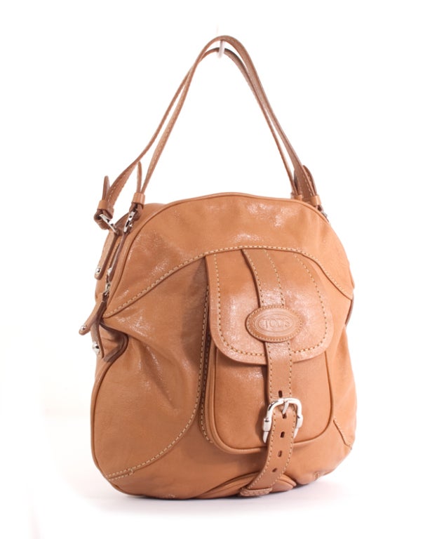 This is an authentic TOD'S Camel Nappa Leather Treccia Bauletto Satchel Bag. Done in lovely Camel Nappa Leather, this bag features bold stitching, a front exterior pocket with a buckle closure, silver harware and accents, and a zip around closure.