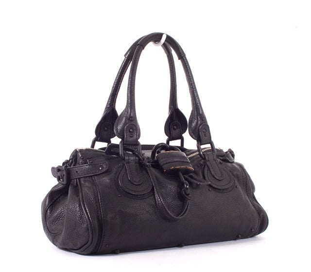This is an authentic CHLOE Leather Limited Edition SO BLACK Paddington Bag. Done in a fantastic black tone, this is a great handbag for everyday. The bag features intense detailing such as chunky hardware, contrasted stitching, and belting while