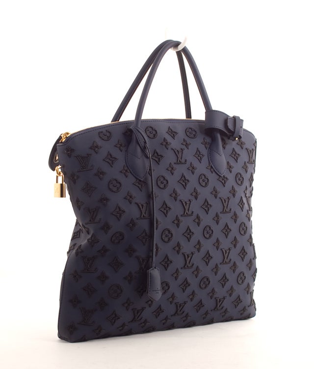 This is a rare, sold out and brand new Louis Vuitton Monogram Addiction Bleu Marine Lockit Vertical. From Louis Vuitton's Fall 2011 collection, this bag was absolutely the biggest hit of the runway and cannot be purchased in stores. Get it here at
