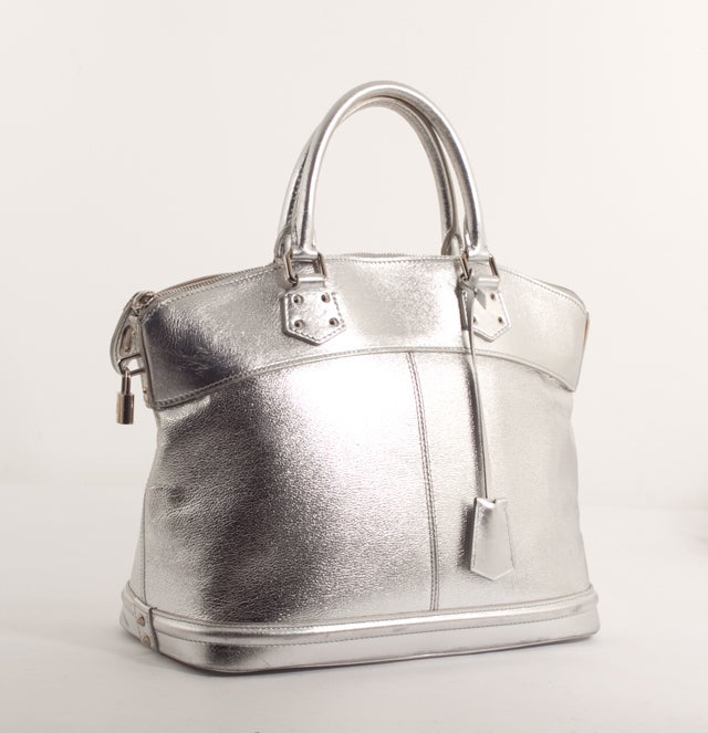 This is an authentic LOUIS VUITTON Silver Suhali Lockit Large Bag Purse Rare. Louis Vuitton calls it one of their most 