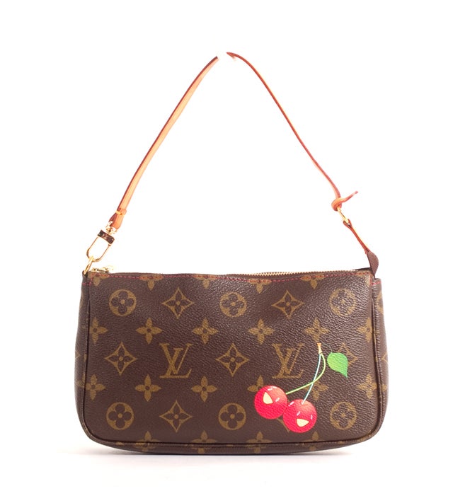 This is an authentic LOUIS VUITTON Cerises Pochette Accessories Bag. It is done in classic Louis Vuitton monogram canvas with a cherry illustration on the front exterior. This bag features golden hardware, a single vachetta leather shoulder strap,