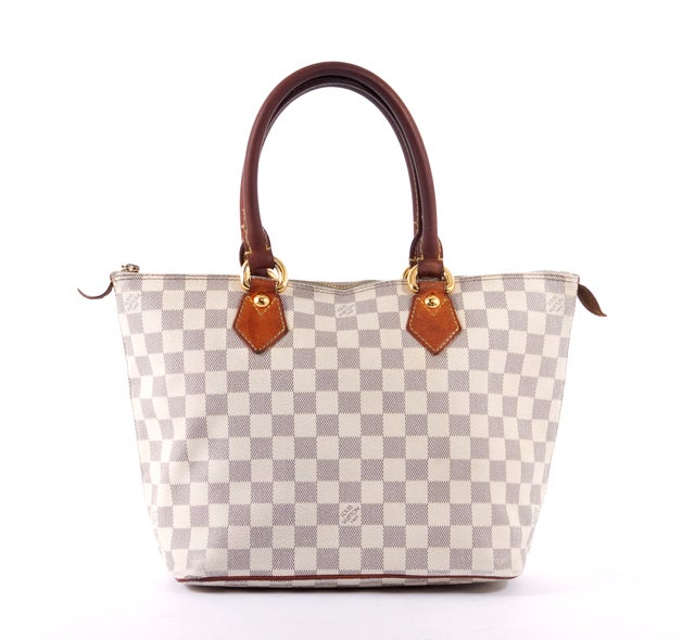 This is an authentic LOUIS VUITTON Damier Azur Saleya PM Tote Bag. It is done in signature Louis Vuitton damier azur coated canvas with smooth leather trim. The bag features a top single zip closure, two comfortable rolled leather handles, and