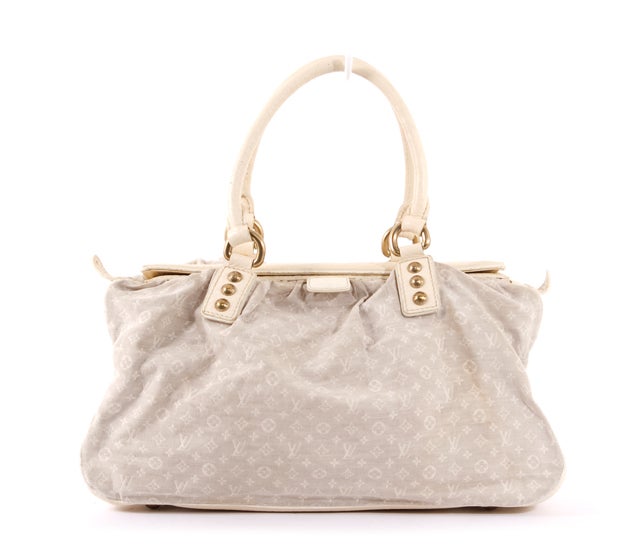 This is an authentic LOUIS VUITTON Mini Lin Sand Beige Trapeze GM Bag. It is done in lovely ivory mini lin monogram canvas with the most supple pebbled leather at the sides and base of the bag. It features two rolled handles, gold toned hardware,