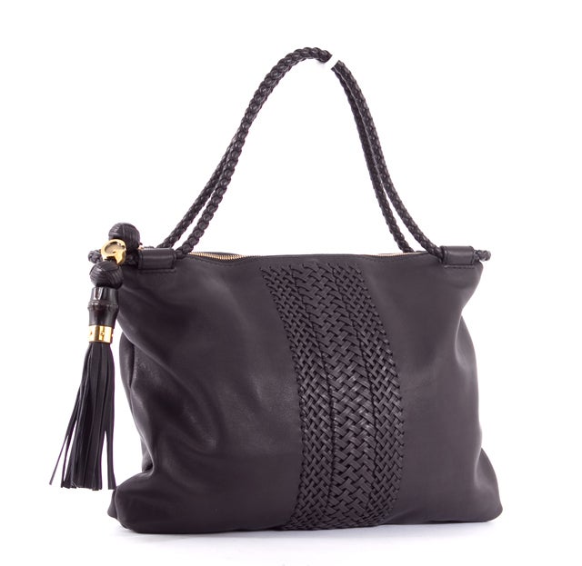This is an authentic GUCCI Black Leather HANDMADE Woven Front Tassels Medium Shoulder Tote Bag. Done in amazing black leather, this bag features a flat structure, woven details, gold hardware, and a single zip closure with a tassel accented zipper
